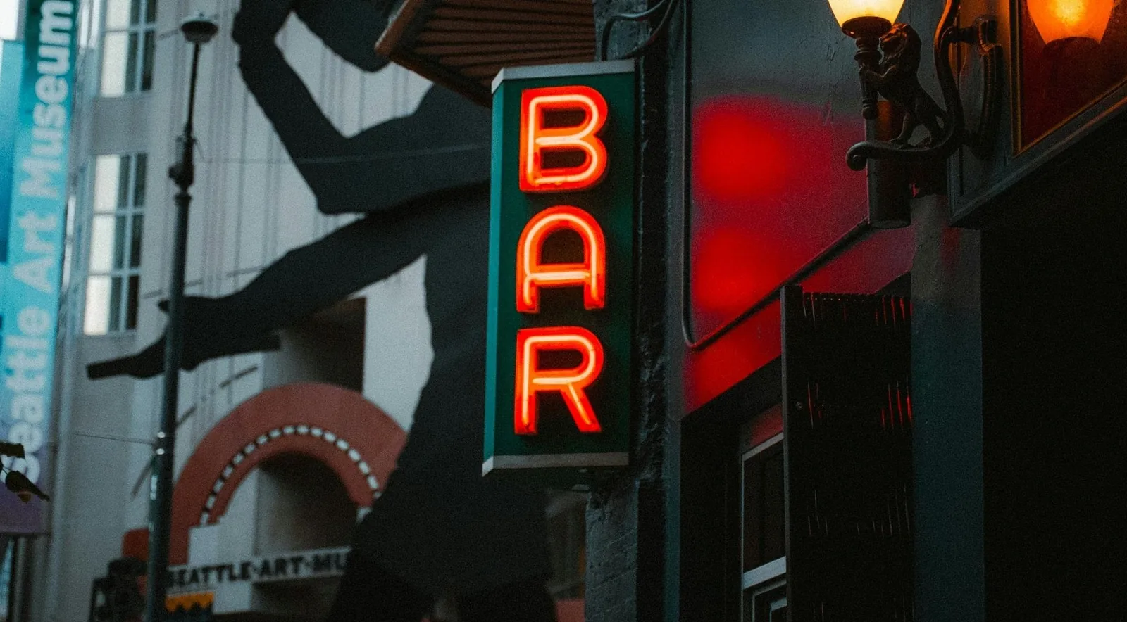 A glowing BAR neon sign beside the Seattle Art Museum downtown