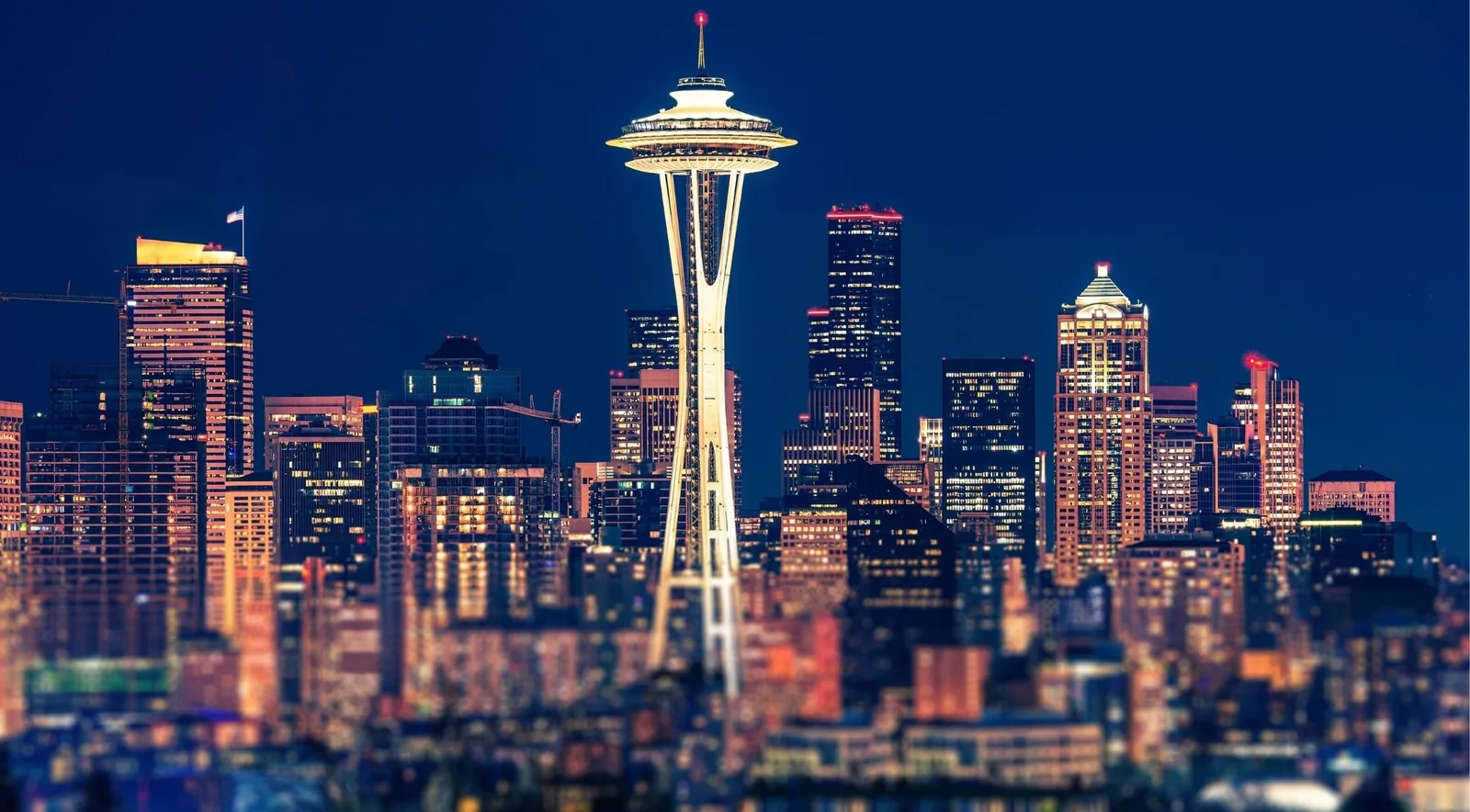 The Space Needle and downtown Seattle skyline lit up at night